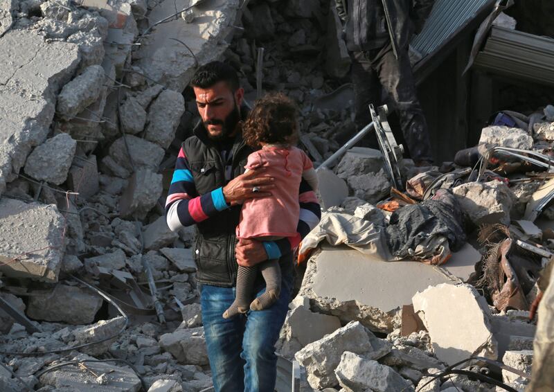 A Syrian man carries a child following a reported airstrike on the rebel-held town of Atareb in Syria's northern Aleppo province on November 13, 2017.
At least 21 civilians, including five children, were killed on Monday in air strikes on Syria's northern Aleppo province, despite a "de-escalation zone" in place there, the Britain-based Syrian Observatory for Human Rights said .
 / AFP PHOTO / Zein Al RIFAI