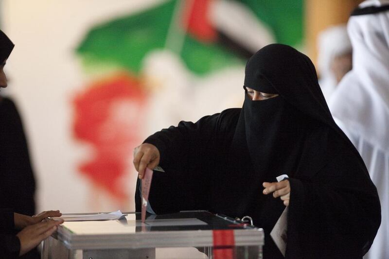An Emirati woman cast her vote in a box at the Ministry of Culture during the FNC elections. Jaime Puebla / The National