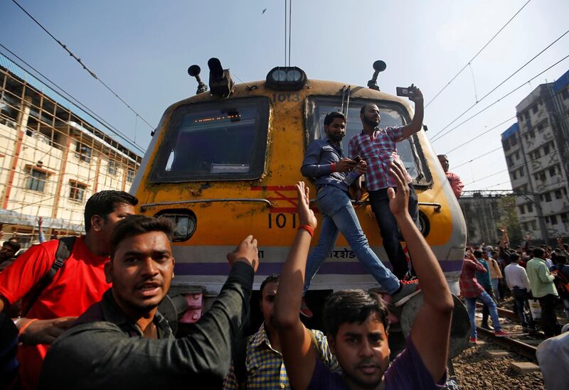 People shout slogans as they block train services during a protest demanding recruitment into the railway services in Mumbai, India, March 20, 2018. REUTERS/Francis Mascarenhas