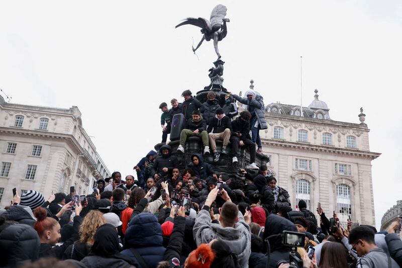 British rapper Digga D is surrounded by fans as he films a music video on the Eros statue at Piccadilly Circus, central London. Reuters