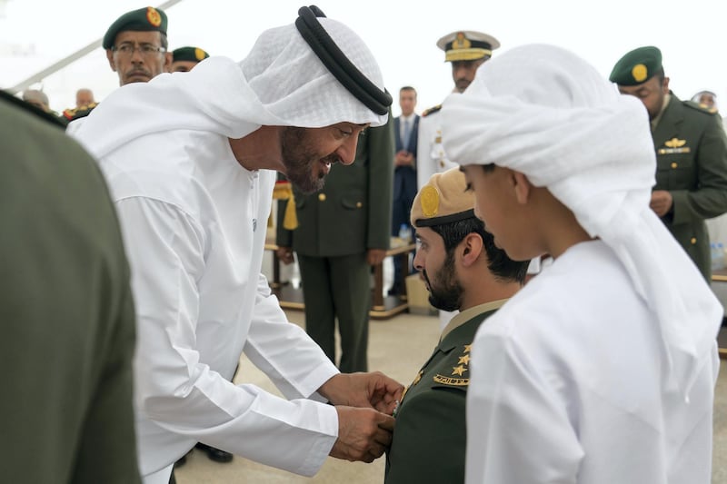 ABU DHABI, UNITED ARAB EMIRATES - April 23, 2018: HH Sheikh Mohamed bin Zayed Al Nahyan Crown Prince of Abu Dhabi Deputy Supreme Commander of the UAE Armed Forces (L), awards HH Sheikh Zayed bin Hamdan bin Zayed Al Nahyan (2nd R), with a Medal of Bravery for his service in Yemen, during a Sea Palace barza. Seen with HH Sheikh Rashid bin Hamdan bin Zayed Al Nahyan (R).

( Rashed Al Mansoori / Crown Prince Court - Abu Dhabi )