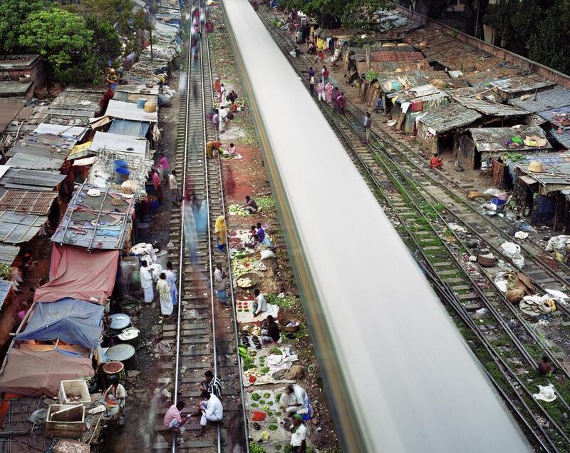 For his Metropolis series, Martin Roemers captured a train track in Dhaka, Bangladesh, which shows slum dwellers and vendors alongside a speeding train. Martin Roemers