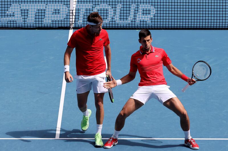 Serbia's Novak Djokovic reacts on a point along teammate Filip Krajinovic. AFP