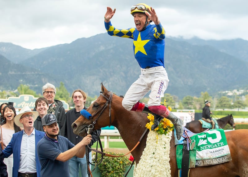 Jockey Lanfranco Dettori celebrates as he jumps off Newgate after winning the Grade I $400,000 Santa Anita Handicap horse race in Arcadia, California. AP
