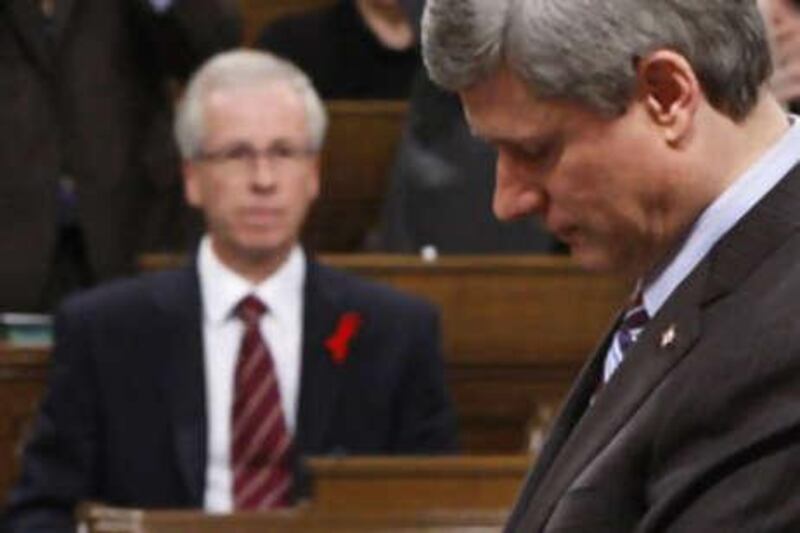 The Liberal leader Stéphane Dion, left, looks on as the Canadian Prime Minister Stephen Harper speaks in the House of Commons in Ottawa on Dec 1 2008.