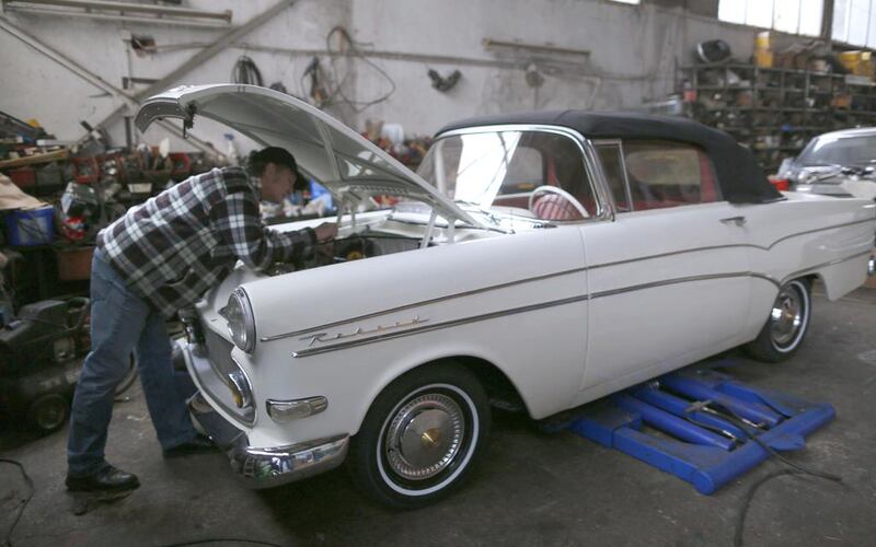 Hilmar Born, the owner of the Opel museum looks at his vintage Opel ‘Rekord’ car. Ina Fassbender / Reuters