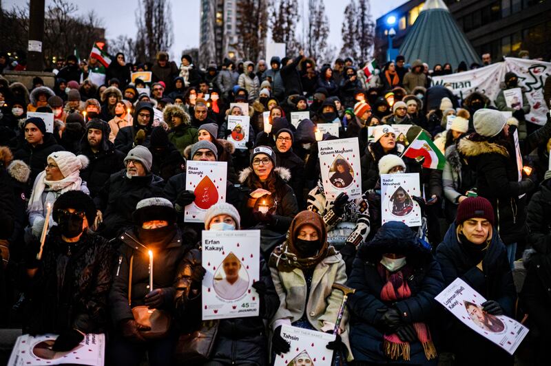 People attend a vigil in Toronto, marking the third anniversary of the doomed flight PS752, which was shot down by Iran’s Islamic Revolutionary Guard Corps shortly after take-off, killing all 176 people on board. AP