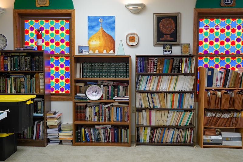 Books line the walls of the small mosque.