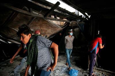 Rescuers and civilians look for bodies after a catastrophic blaze erupted at a hospital in Nasiriyah. AP
