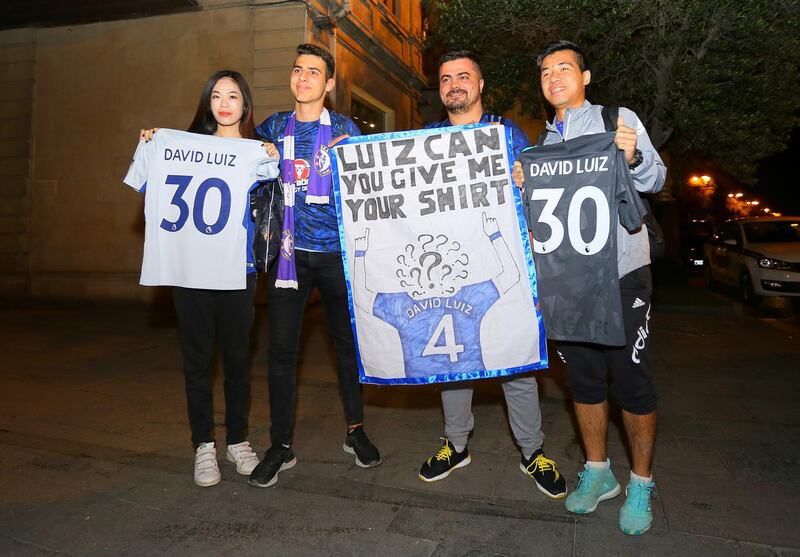 Chelsea supporters hold banners and shirts as the team arrives in Baku for the Europa League fina. Reuters