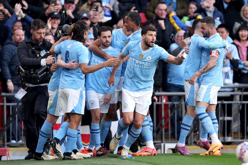 Bernardo Silva is mobbed by teammates after scoring the only goal of the game as Manchester City beat Chelsea at Wembley Stadium in London, on April 20, 2024. Getty Images
