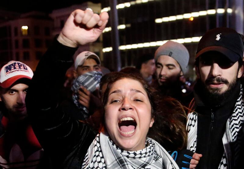 An anti-government protester shouts slogans, during ongoing protests against the ruling elite of corruption and financial crisis, in Beirut, Lebanon.  AP