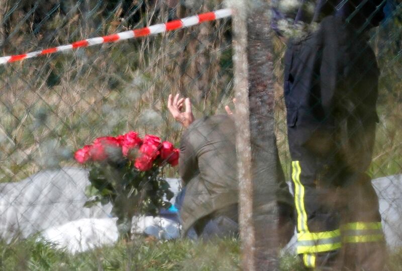 epa07478232 A man, crouching next to flowers, mourns at the crash site of an airplane, on an asparagus field in Erzhausen near Darmstadt, Germany, 01 April 2019. According to police, three people, including Russian airline co-owner and one of Russia's richest woman, Natalia Fileva, died in the aircraft crash on 31 March 2019.  EPA/RONALD WITTEK
