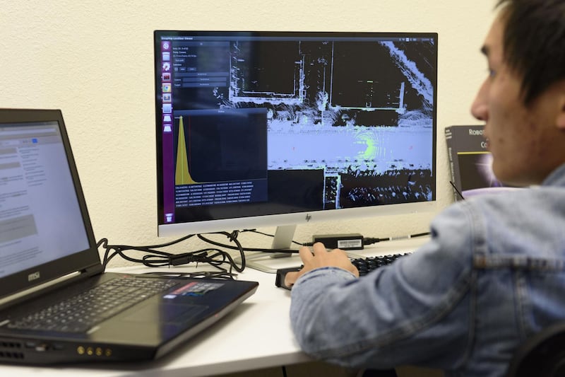A software engineer works on mapping software at the DeepMap Inc. office in Palo Alto, California, U.S., on Wednesday, April 5, 2017. DeepMap Inc., which was founded by mapping veterans ofÂ Alphabet Inc.,Â is building systemsÂ enabling self-driving cars to steer through complex cityscapes. Photographer: Michael Short/ Bloomberg
