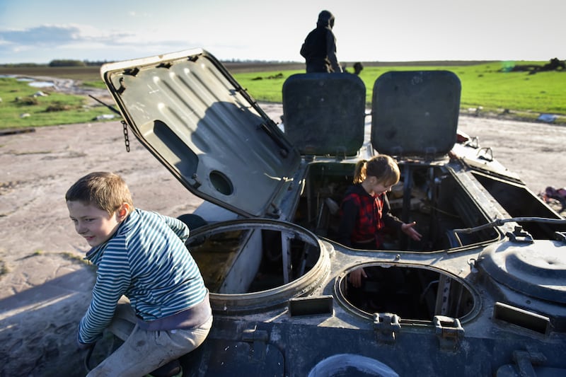 Children play in the wreckage of a Russian armoured vehicle in Lukashivka, Chernihiv region, northern Ukraine. The village has been retaken by Ukrainian forces. EPA