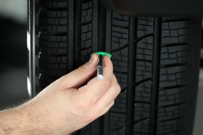 Ryan Hughes checks the tyre tread on a vehicle. Keeping tyres in top condition is vital as temperatures increase.


