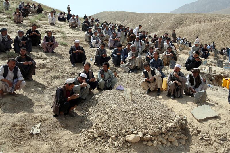 Afghans pray during the funeral of a victim who died in Wednesday's deadly suicide bombing. AP