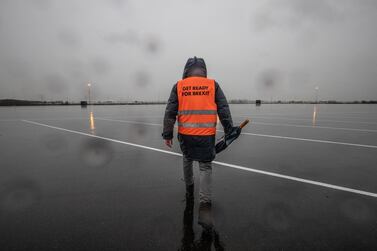 A worker wears a 'Get Ready for Brexit' hi-viz vest in a temporary buffer parking area at the Port of Rotterdam. Netherlands, as Britain and  EU talks go to the wire on a trade deal. Bloomberg 