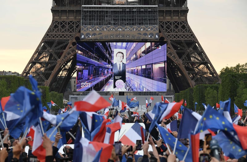 Cheers of joy erupted as Mr Macron's re-election was announced on a giant screen at the foot of the Eiffel Tower. AFP