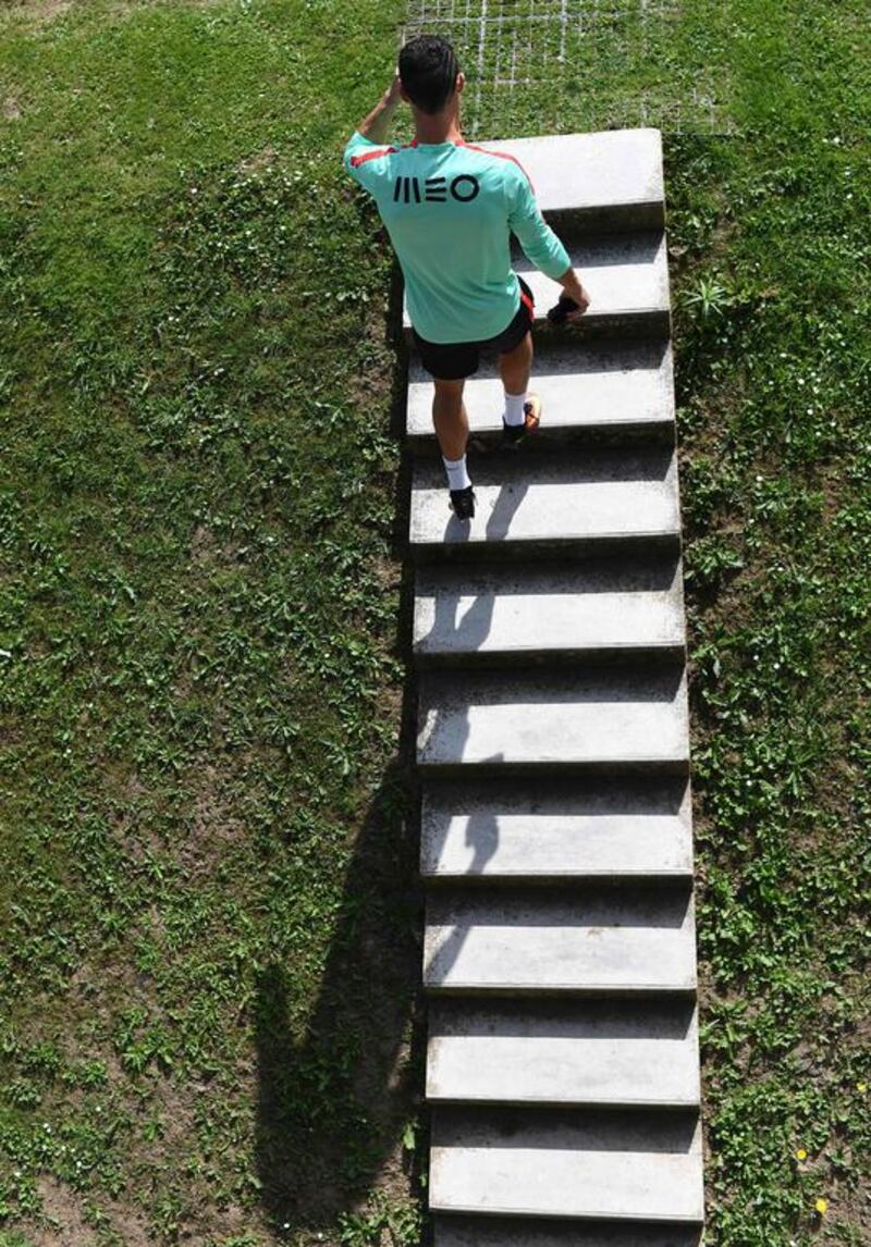 Portugal’s forward Cristiano Ronaldo climbs a stairway as he arrives for a training session at the team’s training ground in Marcoussis, south of Paris, on July 8, 2016, ahead of their Euro 2016 final football match against France. / AFP / FRANCISCO LEONG