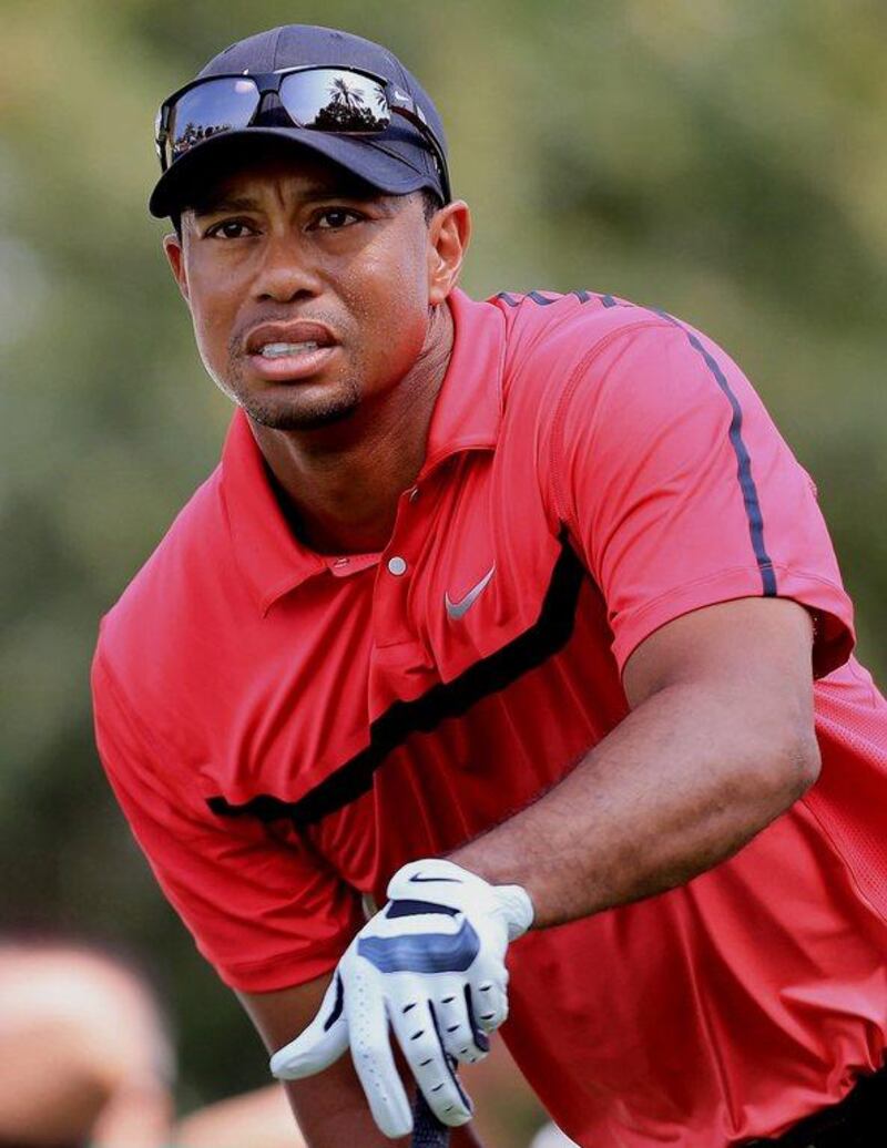 Tiger Woods follows his ball after he tees off at the 14th hole during the final round of the Dubai Desert Classic on Sunday. AP Photo