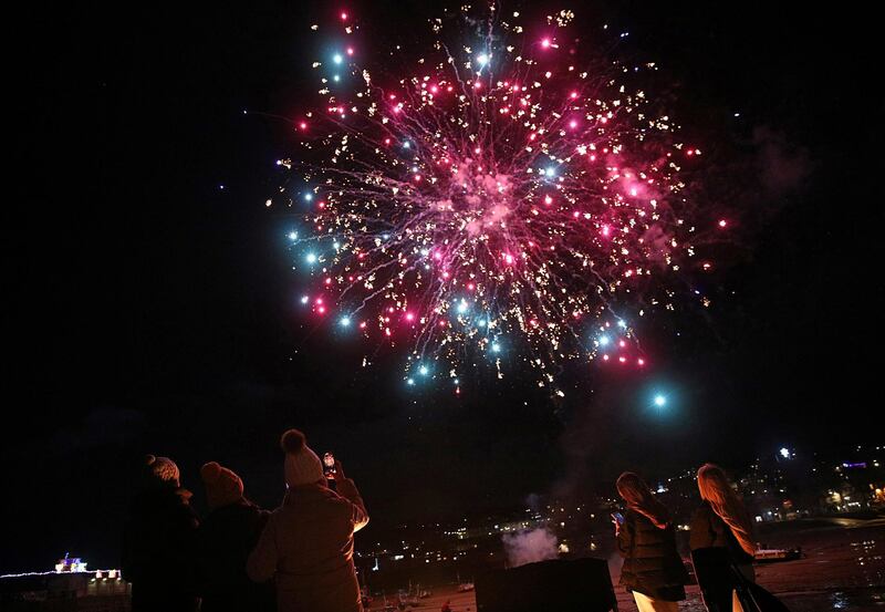 People photograph fireworks during New Year celebrations in St Ives, Cornwall. Reuters