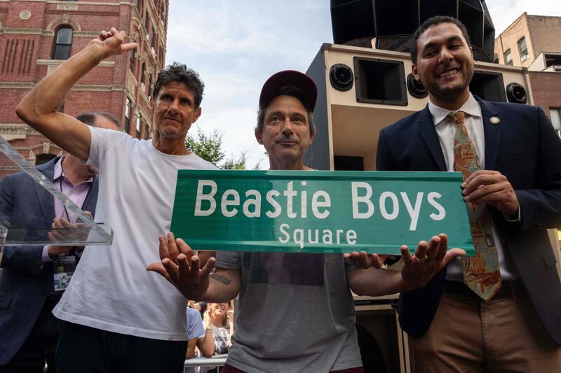 Adam “Adrock” Horowitz (C) and  Michael “Mike D” Diamond (L) of the hip hop music band Beastie Boys, with New York City Council Member Christopher Marte unveil "Beastie Boys Square," in the Manhattan borough of New York City.  The corner at the intersection of Ludlow and Rivington streets was the gatefold cover for the band's second album “Paul’s Boutique. ” AFP