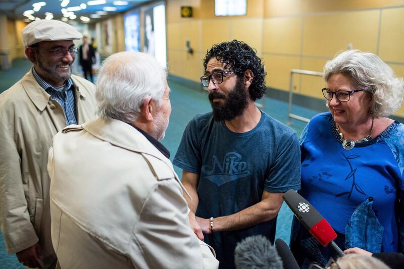 Hassan Al Kontar meets supporters after arriving at an airport in Vancouver, British Columbia, after flying from Kuala Lumpur, Monday, Nov. 26, 2018. Al Kontar, a Syrian man who was stranded for seven months at the Kuala Lumpur International Airport, arrived in Vancouver on Monday night. (Ben Nelms/The Canadian Press via AP)