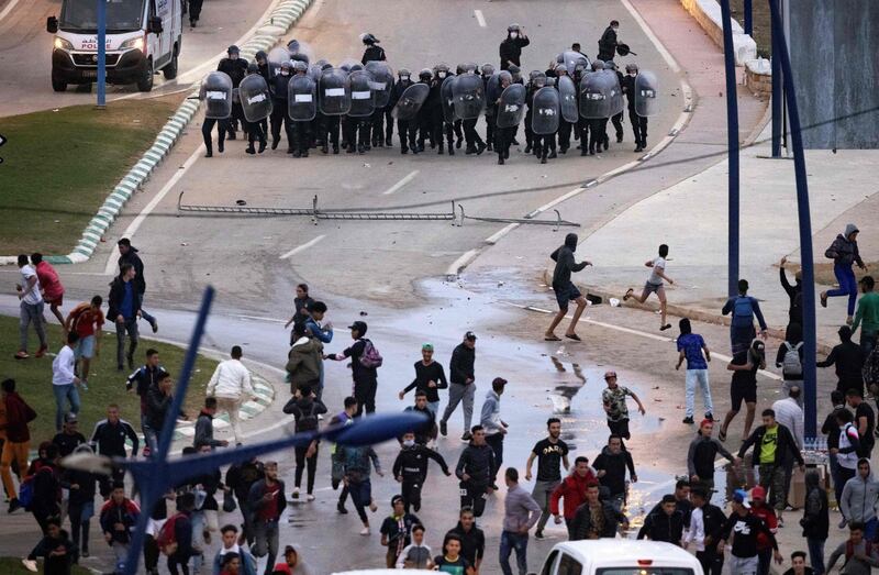 Migrants face-off with Moroccan riot police in the northern town of Fnideq. Many are still trying to cross from Morocco into the Spanish enclave of Ceuta. AFP
