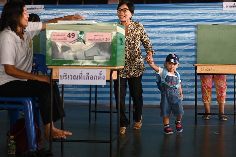 A woman casts her ballot at a polling station in Bangkok. AFP