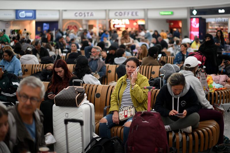 Passengers at Stansted Airport where flights were delayed because of a technical issue. AFP
