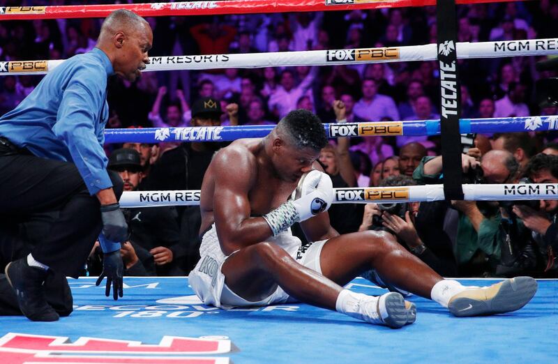 Luis Ortiz sits in the ring after he was knocked down by Deontay Wilder. AP