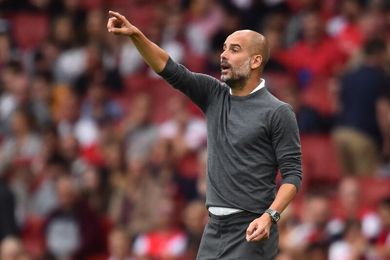Manchester City's Spanish manager Pep Guardiola gestures on the touchline during the English Premier League football match between Arsenal and Manchester City at the Emirates Stadium in London on August 12, 2018. - Manchester City won the game 2-0. (Photo by Glyn KIRK / AFP) / RESTRICTED TO EDITORIAL USE. No use with unauthorized audio, video, data, fixture lists, club/league logos or 'live' services. Online in-match use limited to 120 images. An additional 40 images may be used in extra time. No video emulation. Social media in-match use limited to 120 images. An additional 40 images may be used in extra time. No use in betting publications, games or single club/league/player publications. / 