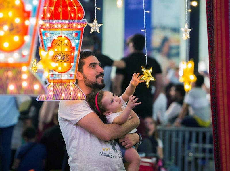 DUBAI, UNITED ARAB EMIRATES, 04 May 2018 - A father with his child at the majlis at Ramadan Market that opens May 3 till 19 at  Dragon Mart 2.  Leslie Pableo for The National for Ellen Fortini's story