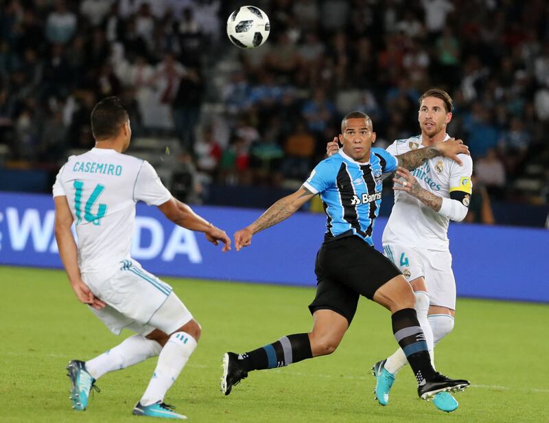 Real Madrid's Sergio Ramos challenges for the ball with Gremio's Brazilian forward Jael. AFP