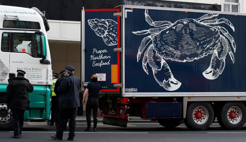 Police speak to shellfish export lorry drivers as they are stopped in London. AP Photo