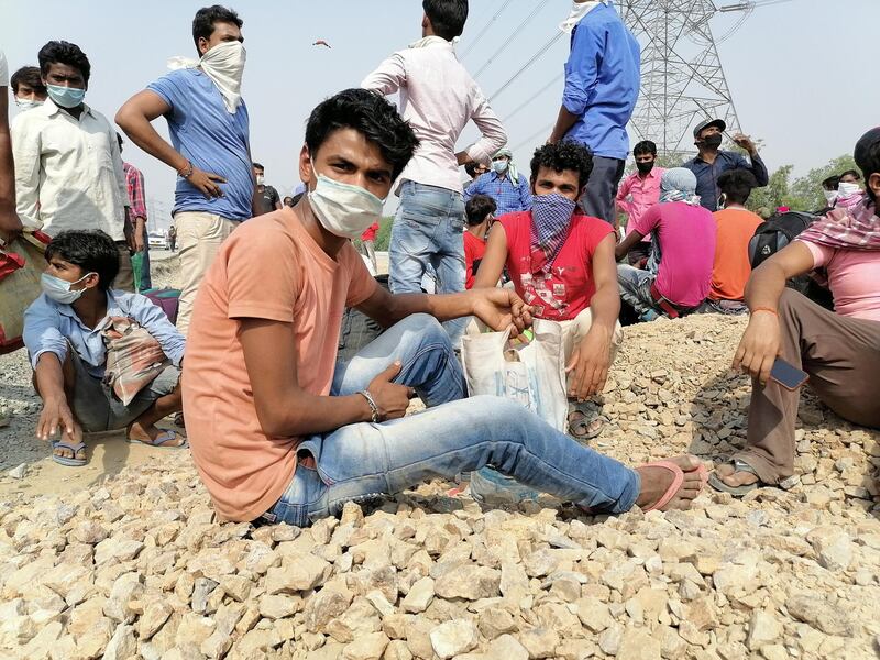 Migrant workers rest on National Highway 24, near Ghaziabad city. Taniya Dutta/The National
