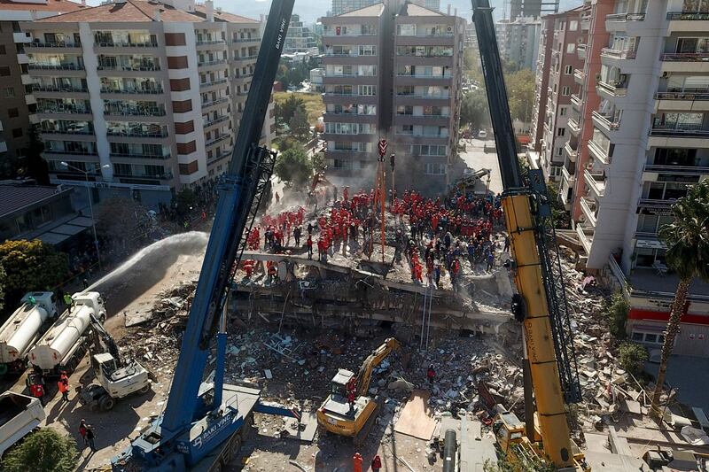 Volunteers and rescue personnel searching for survivors in a collapsed building in Izmir. AFP