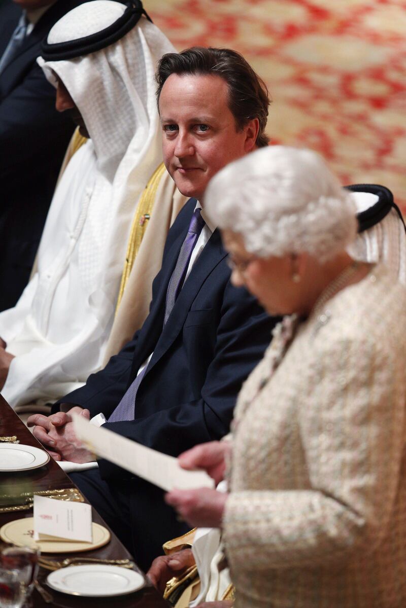 British Prime Minister David Cameron listens as Britain's Queen Elizabeth II delivers a speech at a State Luncheon on the first day of the state visit of Emirati President Sheikh Khalifa bin Zayed al-Nahayan in the Waterloo Chamber in Windsor Castle, Berkshire, west of London on April 30, 2013. Sheikh Khalifa officially began a State visit to Britain with a cermonial welcome in Windsor hosted by the Queen and the Duke of Edinburgh. AFP PHOTO / POOL / OLI SCARFF
 *** Local Caption ***  020534-01-08.jpg