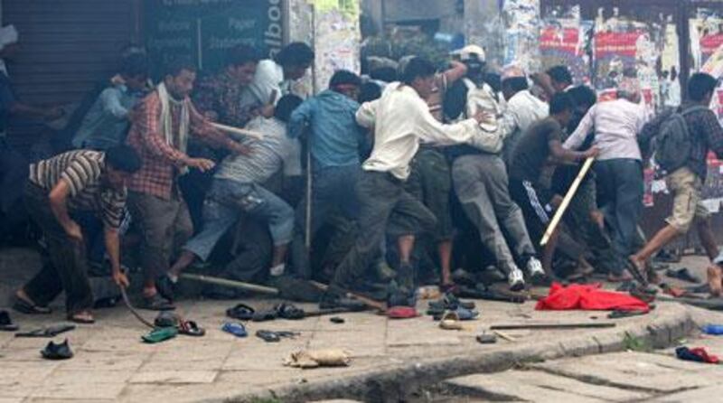 Maoist supporters flee as Nepal policemen fire tear gas to disperse the crowd in Kathmandu on Friday, May 7, 2010.