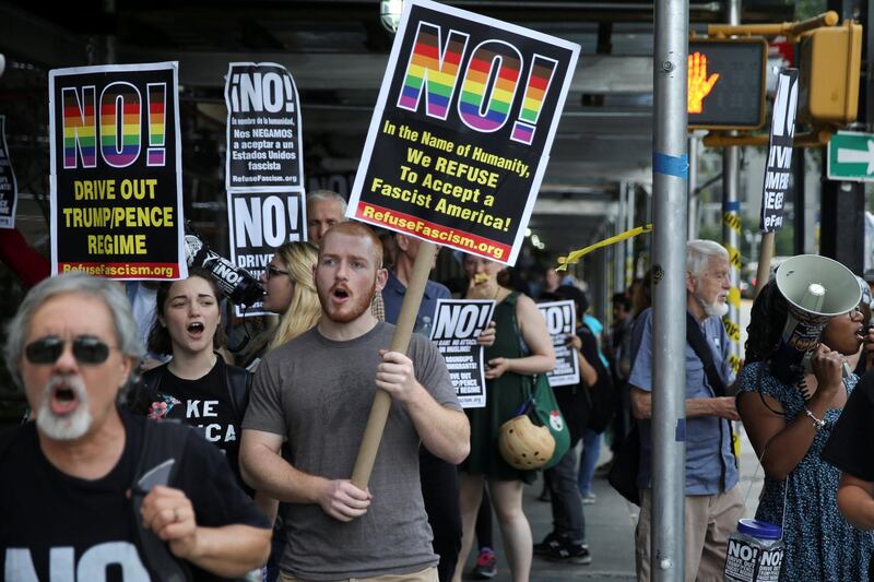 FILE PHOTO: Activists hold placards as they march in protest against the U.S. Supreme Court's decision to revive parts of a travel ban on people from six Muslim-majority countries, in Manhattan, New York, U.S., June 26, 2017.  REUTERS/Amr Alfiky/File Photo