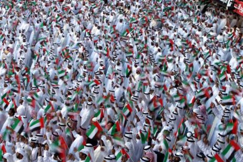 epa03021981 A slow exposure picture shows UAE people waving UAE national flags during the celebration of UAE National day at the Stadium of Sheikh Zayed Sports City in Abu Dhabi , United Arab Emirates, 02 December 2011. The UAE on 02 December celebrated the 40th National Day Official Ceremony, entitled a tribute to the Late Sheikh Zayed.  EPA/ALI HAIDER *** Local Caption ***  03021981.jpg