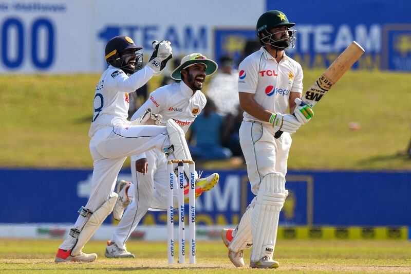 Sri Lanka's wicketkeeper Niroshan Dickwella (L) and teammate Dhananjaya de Silva celebrate after the dismissal of Pakistan's Mohammad Nawaz (R) during the second day of the second cricket Test match between Sri Lanka and Pakistan at the Galle International Cricket Stadium in Galle on July 25, 2022.  (Photo by ISHARA S.  KODIKARA  /  AFP)