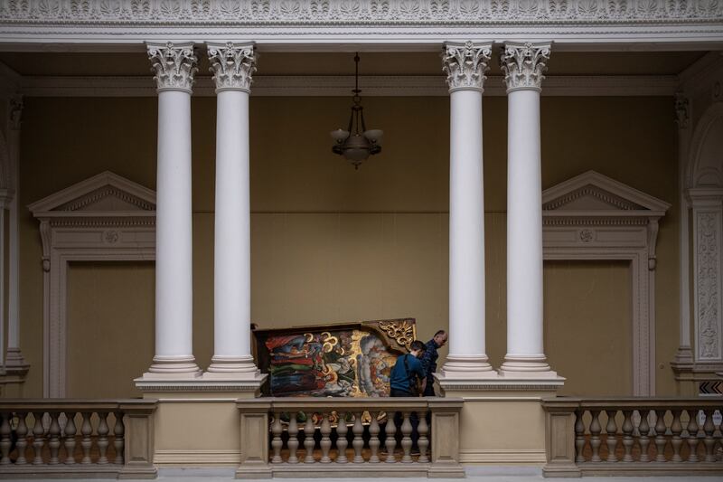 Workers move the Annunciation to the Blessed Virgin of the Bohorodchany Iconostasis.