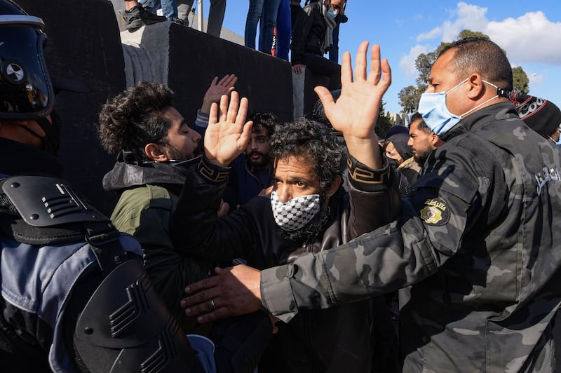 Security forces confront protesters from the Ettadhamen city suburb on the northwestwern outskirts of Tunisia's capital Tunis as they prevent them from passage onwards to reach an anti-government demonstration outside the Tunisian Assembly headquarters.  AFP