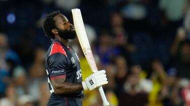 Aaron Jones kisses his bat in celebration after hitting the winning runs for USA in the T20 World Cup match against Canada. AP