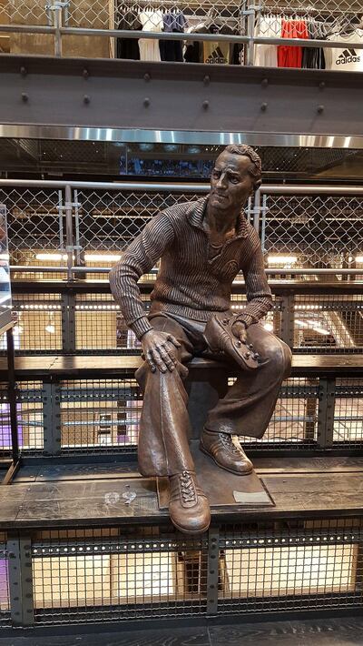 A sculpture of Adidas founder Adi Dassler in an Adidas store in New York City in 2016. Wikicommons