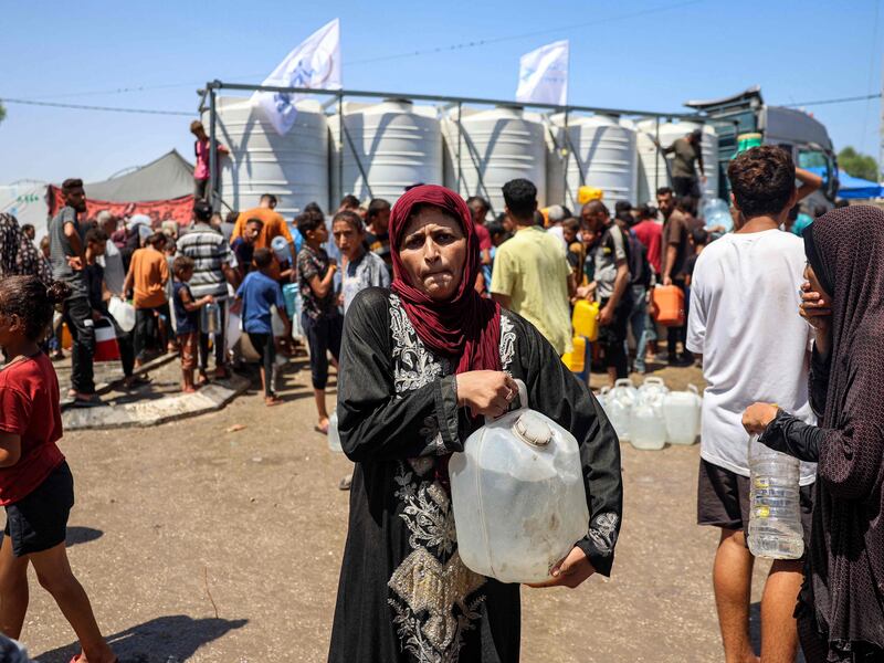 A woman collects water in Rafah, southern Gaza. Palestinians in the enclave have struggled to find water sources as the war rages on. AFP