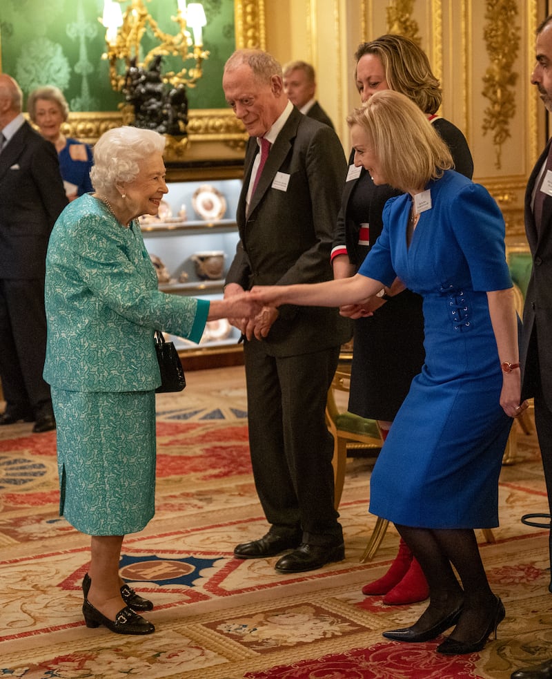 Queen Elizabeth II greeting Ms Truss at a reception for international business and investment leaders at Windsor Castle in October 2021. PA