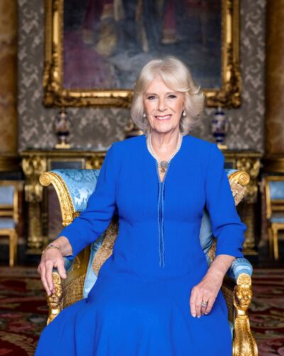 Queen Consort Camilla is pictured wearing a blue wool crepe coat dress designed by Fiona Clare. Reuters